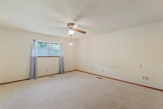 1112 E 11th St, Edmond, OK 73034 - unfurnished room featuring a ceiling fan, baseboards, and light colored carpet