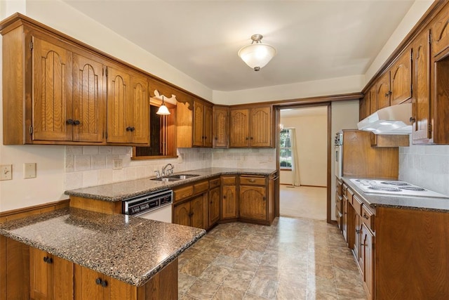 1112 E 11th St, Edmond, OK 73034 - kitchen featuring under cabinet range hood, a peninsula, a sink, white appliances, and brown cabinetry