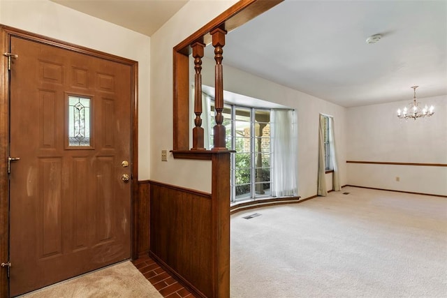 1112 E 11th St, Edmond, OK 73034 - carpeted foyer with a chandelier and wainscoting