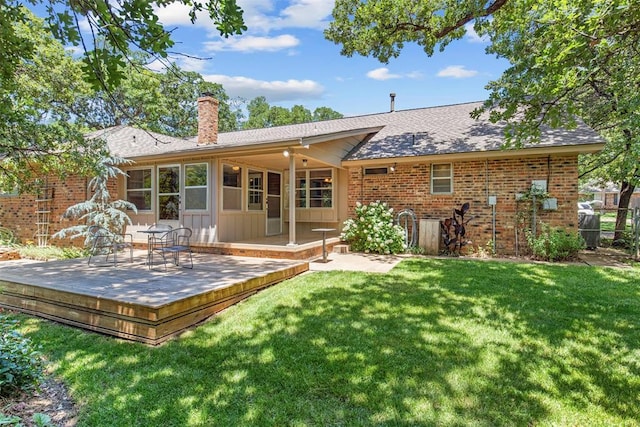 1112 E 11th St, Edmond, OK 73034 - rear view of house featuring a chimney, a wooden deck, brick siding, and roof with shingles