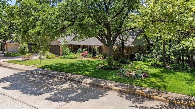 1112 E 11th St, Edmond, OK 73034 - obstructed view of property with a front lawn and brick siding