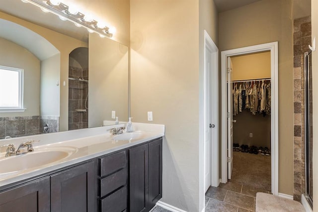 5008 Caleb St, Oklahoma City, OK 73179 - bathroom with tiled shower, double vanity, and a spacious closet