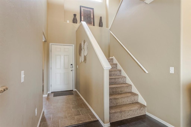 5008 Caleb St, Oklahoma City, OK 73179 - foyer entrance with baseboards, stairway, stone finish floors, and a high ceiling