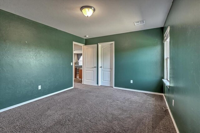 2721 Demotte Dr, Yukon, OK 73099 - unfurnished bedroom with carpet and baseboards