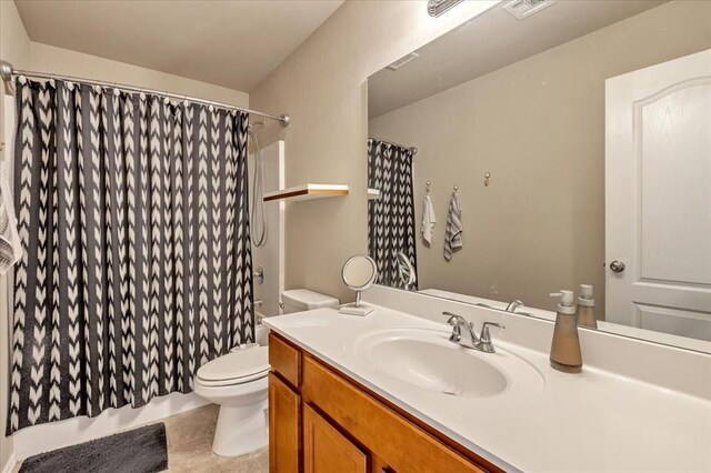 2721 Demotte Dr, Yukon, OK 73099 - full bathroom featuring vanity, toilet, a shower with shower curtain, and tile patterned floors