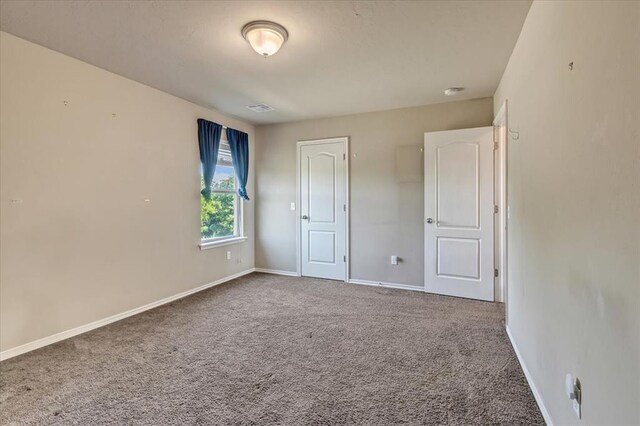 2721 Demotte Dr, Yukon, OK 73099 - unfurnished bedroom featuring carpet and baseboards