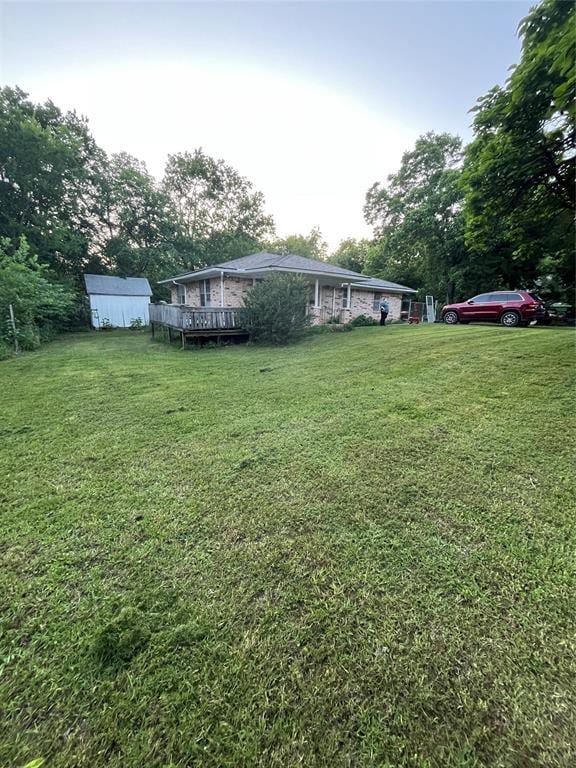 1209 Jefferson St, Seminole, OK 74868 - view of green lawn with a deck