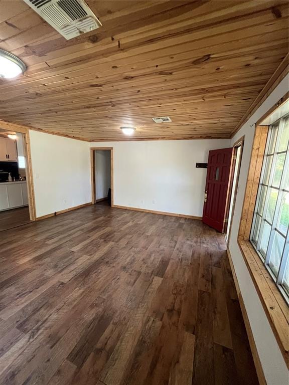 1209 Jefferson St, Seminole, OK 74868 - below grade area with wooden ceiling, dark wood-style flooring, and baseboards