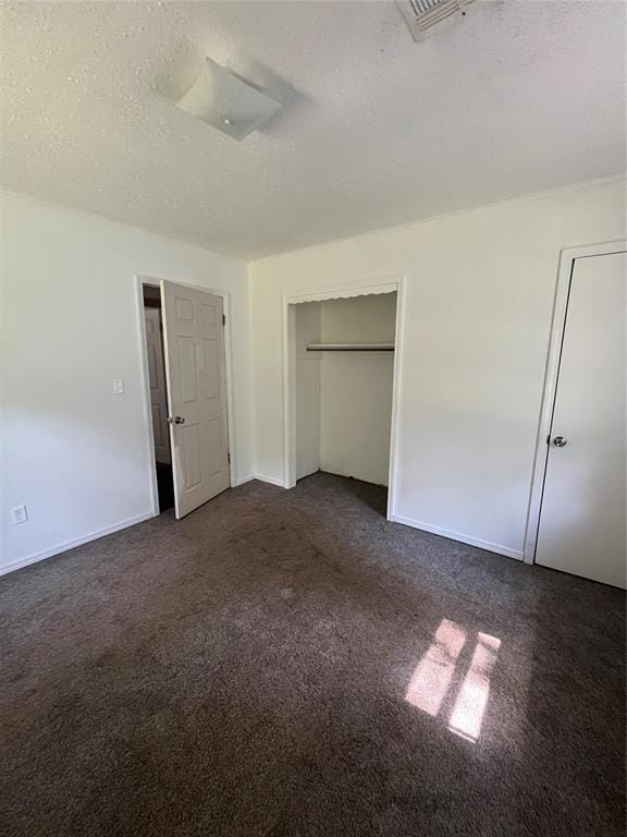1209 Jefferson St, Seminole, OK 74868 - unfurnished bedroom featuring dark carpet, a textured ceiling, and baseboards
