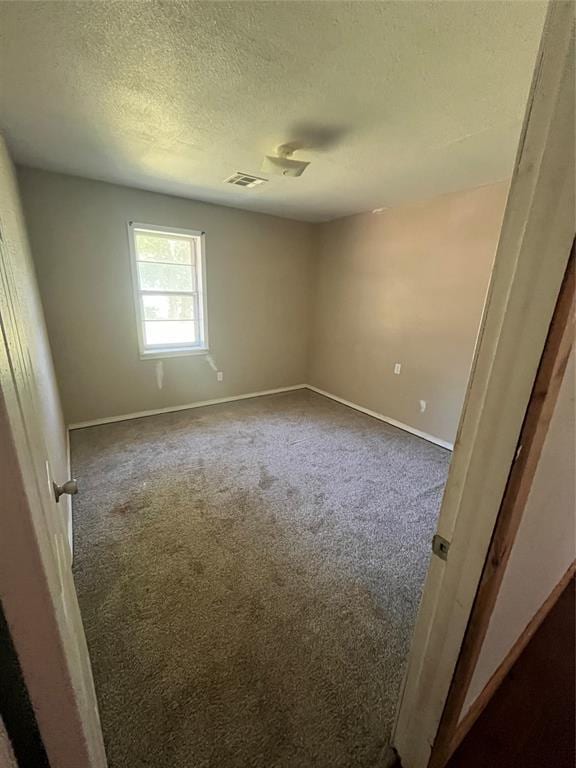 1209 Jefferson St, Seminole, OK 74868 - carpeted empty room featuring a textured ceiling and baseboards