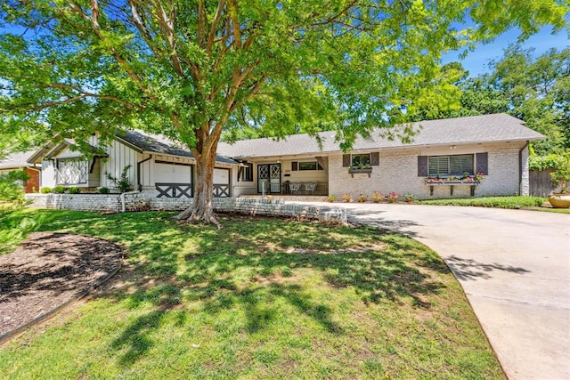 2241 NW 56th St, Oklahoma City, OK 73112 - single story home featuring an attached garage, driveway, a front lawn, and brick siding