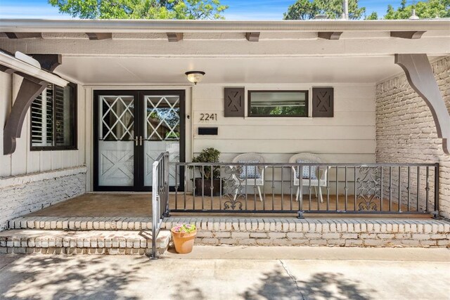 2241 NW 56th St, Oklahoma City, OK 73112 - property entrance with a porch