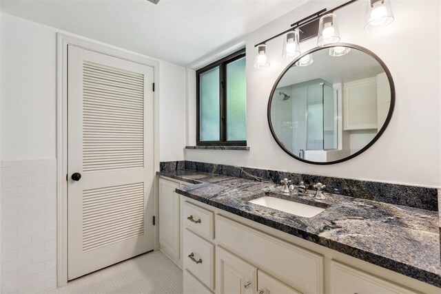 2241 NW 56th St, Oklahoma City, OK 73112 - bathroom with vanity, tile patterned floors, and a shower