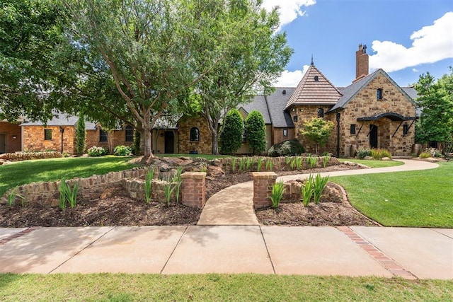 1324 NW 157th St, Edmond, OK 73013 - view of front of house with a front yard, stone siding, and a chimney