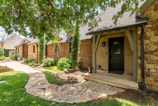 1324 NW 157th St, Edmond, OK 73013 - entrance to property with a shingled roof, stucco siding, and stone siding