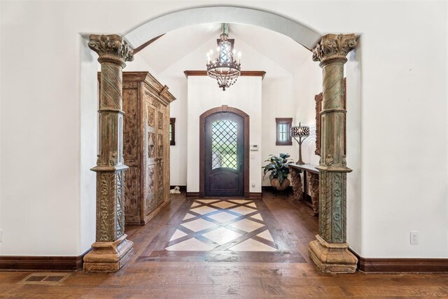 1324 NW 157th St, Edmond, OK 73013 - entryway featuring arched walkways, a chandelier, hardwood / wood-style flooring, baseboards, and vaulted ceiling