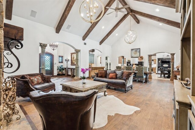 1324 NW 157th St, Edmond, OK 73013 - living area with arched walkways, a chandelier, high vaulted ceiling, beamed ceiling, and light wood-style flooring