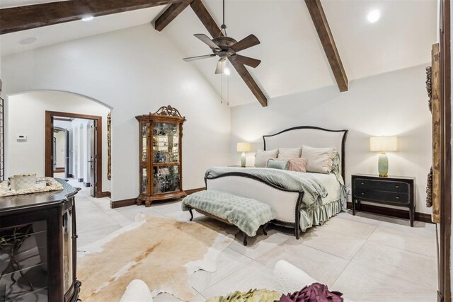 1324 NW 157th St, Edmond, OK 73013 - bedroom with arched walkways, high vaulted ceiling, beam ceiling, light tile patterned flooring, and ceiling fan