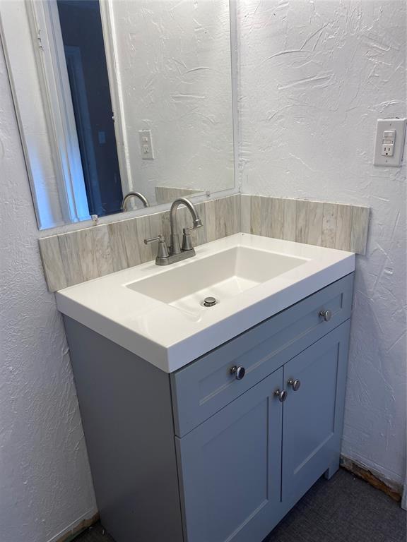 640 SE 20th St, Oklahoma City, OK 73129 - bathroom featuring vanity and a textured wall