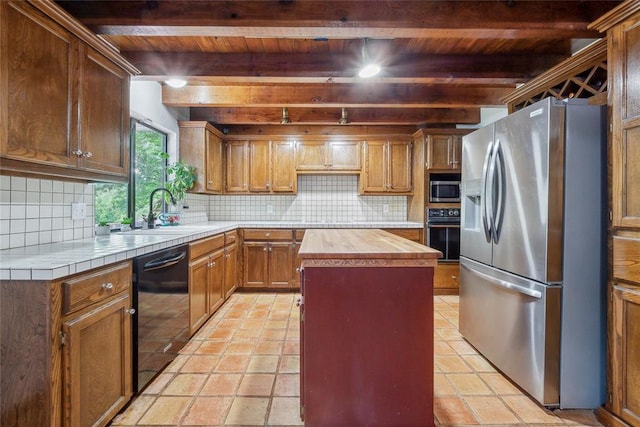 13220 Shady Tree Pl, Edmond, OK 73013 - kitchen with black appliances, wood ceiling with exposed beams, wooden counters, a sink, and backsplash