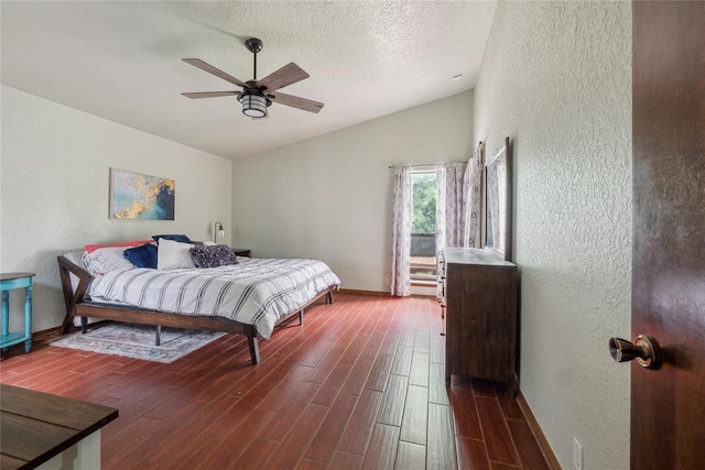13220 Shady Tree Pl, Edmond, OK 73013 - bedroom featuring vaulted ceiling, a textured wall, dark wood-style flooring, baseboards, and a ceiling fan