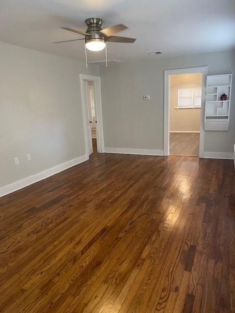 306 E Hughbert St, Norman, OK 73069 - spare room with dark wood finished floors, ceiling fan, and baseboards