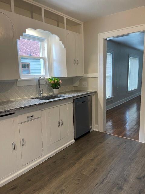 306 E Hughbert St, Norman, OK 73069 - kitchen featuring stainless steel dishwasher, a sink, white cabinets, and plenty of natural light
