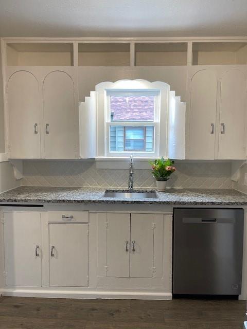 306 E Hughbert St, Norman, OK 73069 - kitchen with stainless steel dishwasher, a sink, white cabinetry, decorative backsplash, and stone countertops