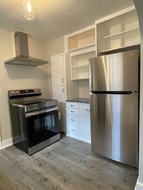 306 E Hughbert St, Norman, OK 73069 - kitchen featuring appliances with stainless steel finishes, wall chimney range hood, open shelves, dark wood finished floors, and baseboards