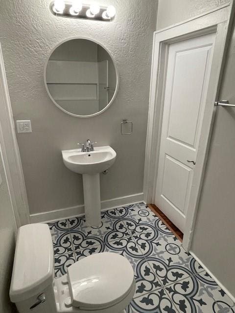306 E Hughbert St, Norman, OK 73069 - half bath with toilet, baseboards, and tile patterned flooring