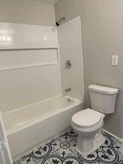 306 E Hughbert St, Norman, OK 73069 - bathroom featuring toilet, bathing tub / shower combination, and tile patterned flooring