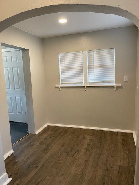 306 E Hughbert St, Norman, OK 73069 - unfurnished room with arched walkways, dark wood-type flooring, baseboards, and recessed lighting