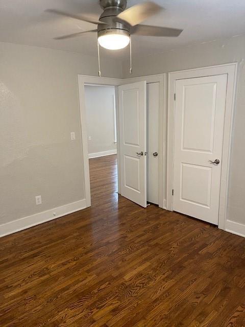 306 E Hughbert St, Norman, OK 73069 - empty room featuring a ceiling fan, dark wood finished floors, and baseboards