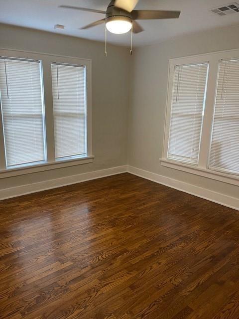 306 E Hughbert St, Norman, OK 73069 - unfurnished room featuring baseboards, dark wood finished floors, and a ceiling fan