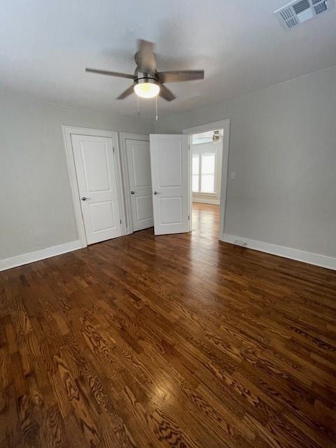 306 E Hughbert St, Norman, OK 73069 - empty room featuring ceiling fan, dark wood finished floors, and baseboards