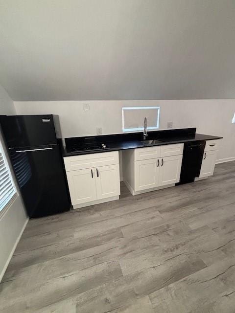 306 E Hughbert St, Norman, OK 73069 - kitchen with black appliances, baseboards, light wood-style flooring, lofted ceiling, and white cabinetry
