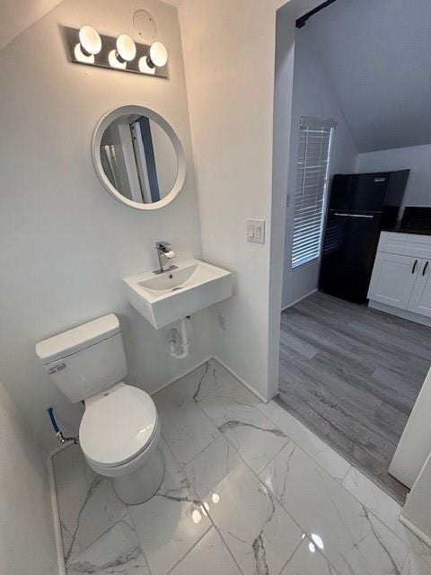 306 E Hughbert St, Norman, OK 73069 - bathroom with marble look tiles, baseboards, and toilet