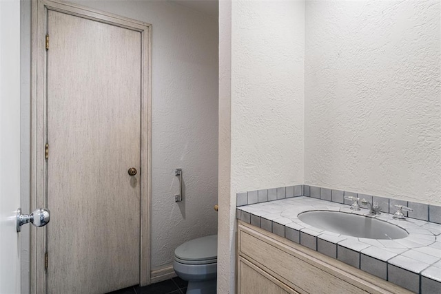 1409 Glenbrook Ter, Nichols Hills, OK 73116 - bathroom with toilet, vanity, a textured wall, and tile patterned flooring
