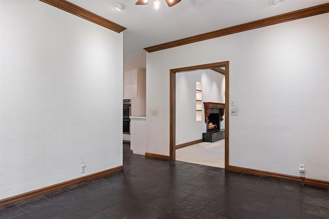 1409 Glenbrook Ter, Nichols Hills, OK 73116 - empty room featuring crown molding, a warm lit fireplace, baseboards, and ceiling fan