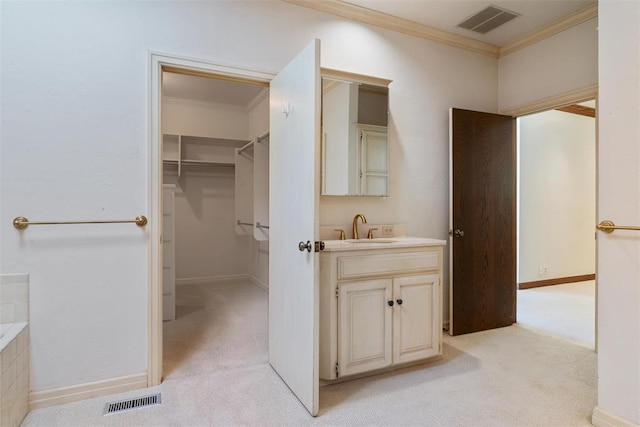 1409 Glenbrook Ter, Nichols Hills, OK 73116 - bathroom with crown molding, vanity, a spacious closet, and baseboards