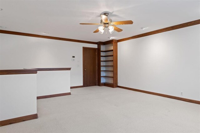 1409 Glenbrook Ter, Nichols Hills, OK 73116 - unfurnished room with baseboards, light colored carpet, a ceiling fan, and ornamental molding