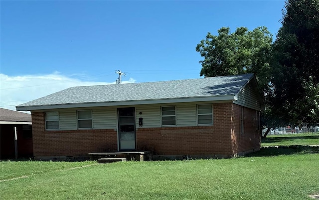 1510 Orient Ave, Clinton, OK 73601 - view of front facade with a front lawn, brick siding, and a shingled roof