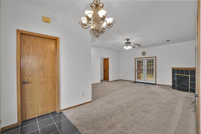 1101 Wendy Ln, Altus, OK 73521 - unfurnished living room with ceiling fan, a fireplace, a chandelier, baseboards, and dark tile patterned floors