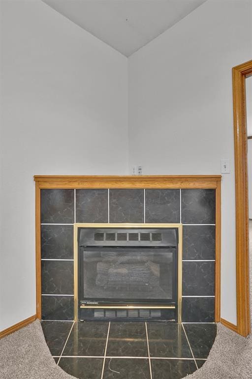 1101 Wendy Ln, Altus, OK 73521 - detailed view of carpet floors, baseboards, and a tiled fireplace