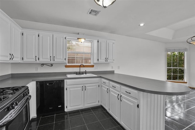 1101 Wendy Ln, Altus, OK 73521 - kitchen featuring a sink, black appliances, a peninsula, dark tile patterned floors, and recessed lighting