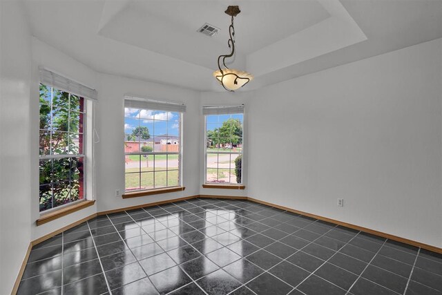1101 Wendy Ln, Altus, OK 73521 - unfurnished room featuring plenty of natural light, a raised ceiling, and baseboards
