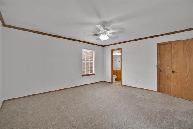 1101 Wendy Ln, Altus, OK 73521 - unfurnished bedroom featuring baseboards, carpet flooring, ornamental molding, connected bathroom, and a closet