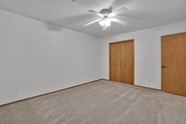 1101 Wendy Ln, Altus, OK 73521 - unfurnished bedroom featuring carpet flooring, baseboards, a closet, and a ceiling fan