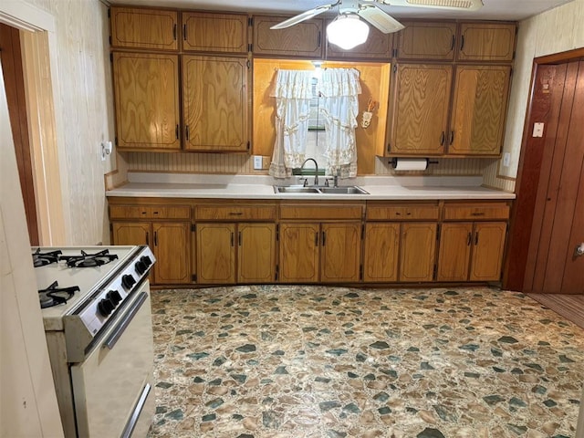 316 N Crenshaw St, Wayne, OK 73080 - kitchen featuring a sink, white range with gas cooktop, brown cabinetry, and light countertops