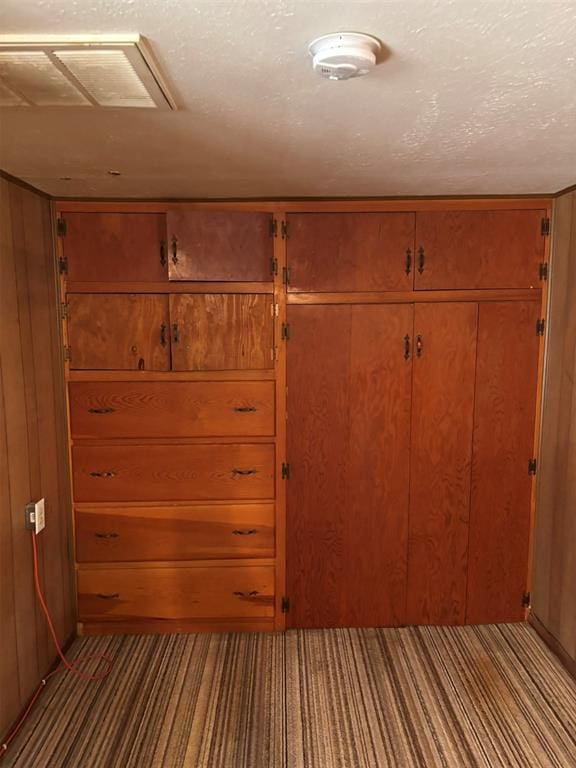316 N Crenshaw St, Wayne, OK 73080 - unfurnished bedroom featuring carpet floors, a closet, wood walls, and a textured ceiling